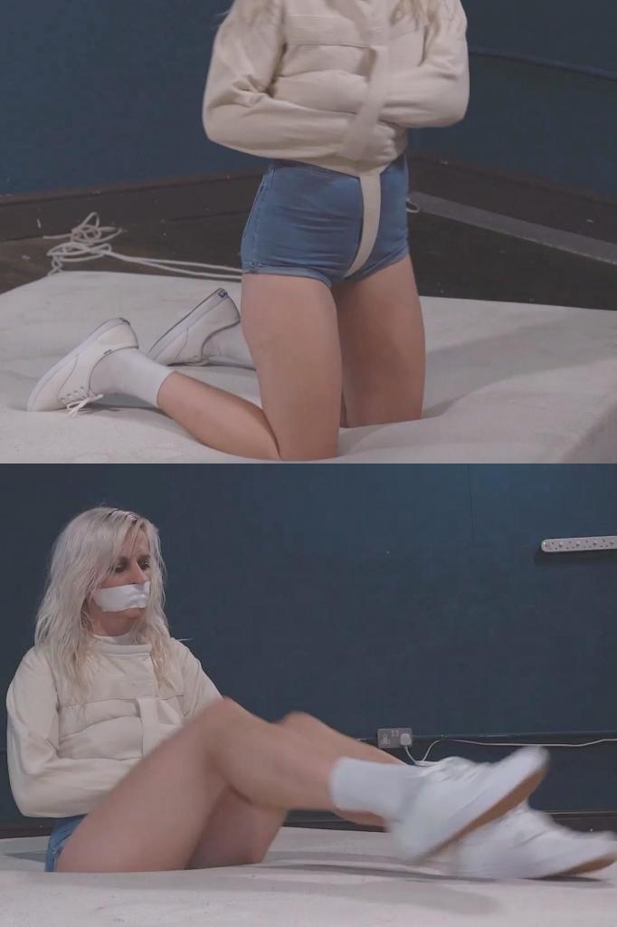 5233 Sandy in Strapped into Straitjacket 即使是Keds运动鞋也无法让桑迪逃脱厄运。她被塞进外套里，嘴里还塞了一块微泡沫条。她只能在床垫上挣扎。Even Keds dont make Sandy fast enough to get away from the inevitable. In the jacket she goes, gagged with a strip of microfoam too. Left to struggle on the mattress.