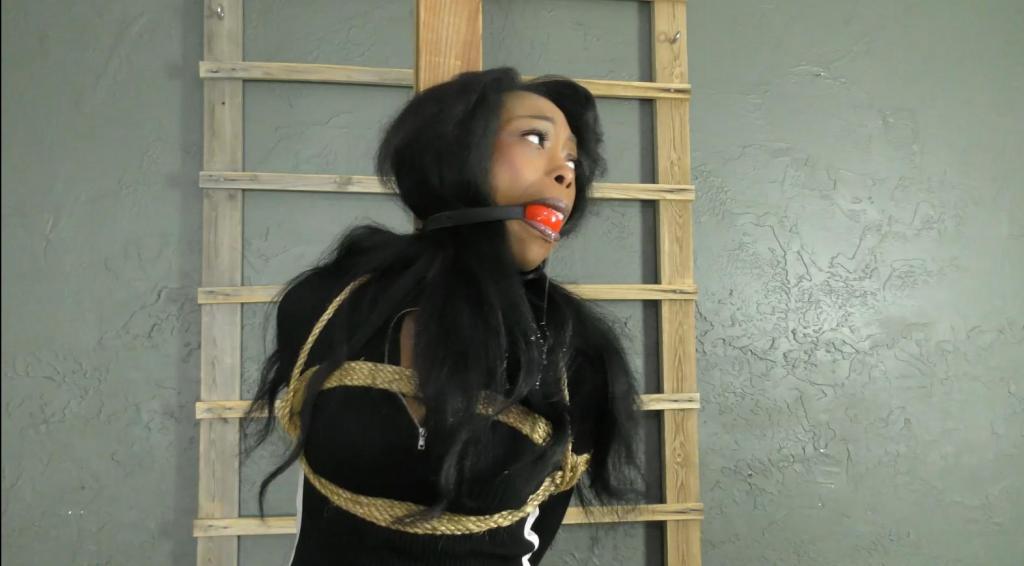 QT1426 Rosa Violetta (is-qt-rv010)  Rosa, one hand cuffed and clearly on the run, approaches a guest house at the back of a property and is shocked to see an apparent bondage photo studio! 