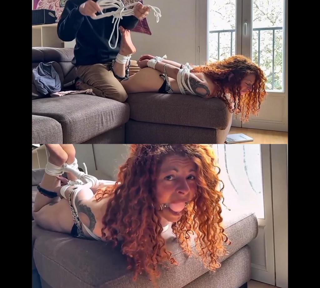 Lola Bound, Gagged and Threatened by an Intruder – Bondage Home Invasion Lola is enjoying a quiet moment alone, relaxing on the couch with a book? when an intruder suddenly breaks in, hand gags her an takes control.<br><br>Caught completely off guard, she is quickly overpowered, stripped and restrained. Her wrists are secured, followed by her ankles, while white rope is wrapped tightly around her body in a firm chest harness, leaving her with almost no freedom of movement.<br><br>Her attempts to call for help are cut short, first muffled, then silenced completely as she is firmly gagged with a pink huge ballgag. Left struggling and helpless, Lola squirms against the tight ropes, but only finds herself more restricted with every movement The tension escalates as the intruder reveals a personal photo on his phone, using it as a threat to ensure her compliance and silence. With no way to escape and no one to hear her, Lola is left entirely at his mercy.<br><br>Finally, she is put into a strict hogtie, bound tightly with white rope and abandoned to struggle alone, gagged, restrained, and completely silenced.<br><br>Will anyone come to her rescue? or is she truly trapped?<br><br>