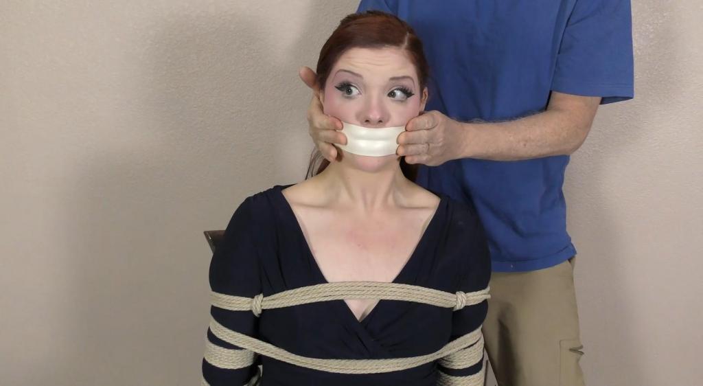 QT1433 Daisy Daniels (is-qt-dd076) Shot POV style, Daisy , a sweet but naïve midwestern gal, answered a call for D.I.D. models. Unfortunately for Daisy, she didn’t know that D.ZI.D. meant Damsel in Distress and now she is bound to a chair with a whole lot of rope! Daisy talks to the camera until she is gagged with a single piece of microfoam tape, which nicely conforms to her lips leaving a lovely outline!