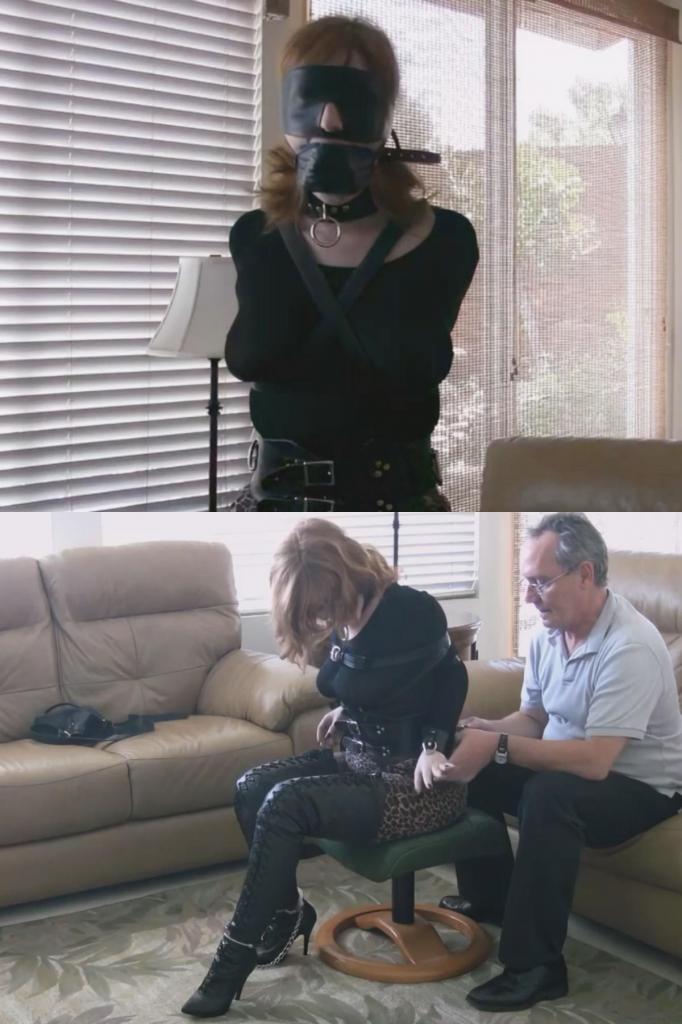 Ginger - Redhead Restrained - Part 1 主演：姜。在“新束缚朋友”中，我解开了姜身上的绳索捆绑后，这位皮肤白皙、一头火红头发的姜并没有逃出门外，也没有要求摘掉她身上锁着的皮质奴隶项圈。相反，她想尝试另一种捆绑方式。我给她看了一只手套，她说她从来没试过。我建议我们给她换身衣服，她还可以试试我们的过膝系带长靴。这双靴子很少借给客人，因为它是为脚很小的人设计的。姜个子不高，所以靴子一直延伸到她的大腿根部，看起来很酷。给她系鞋带的过程相当愉快。视频开始时，姜已经穿好了衣服，也穿上了靴子。我用一条宽皮带系住她的腰部。皮带和她系得紧紧的靴筒完美地衬托出姜可爱的臀部。接下来是束缚手臂的时间，影片在束缚过程中逐渐淡入淡出，以保持节奏，力求保留两个束缚者初次见面时的“真实”场景。我蒙住无助的臣服者的眼睛，堵住她的嘴，然后停下来拍照。之后她的手臂麻木了，于是我们一起取下那只手套，感受着她手臂和手部恢复麻木的轻松感。然后我开始重新束缚她，让她无法动弹，以免影响她手臂的恢复。这里一个手铐，那里一把锁，几根皮带就足够了。再加个脚镣方便移动。金吉尔喜欢尝试逃脱。没有帮助，她根本不可能挣脱那只手套，但现在她看到了机会。哦，如果她能把手腕从锁住的手铐里挤出来就好了！抱歉亲爱的，有办法解决这个问题。Starring Ginger. After I released her from the rope hogtie in New Bondage Friend, Ginger of fair skin and fiery red hair, did not run out the door, nor ask that her locked leather slave collar be removed. Instead, she wanted to get tied up in a different way. I showed her a single glove and she said she had never tried one. I suggested we change her costume, and she could try our thigh high lace up boots as well. That pair is not shared often with visitors as they are for very small feet. Ginger is not tall so the boots came way up her thighs and looked cool. It was rather pleasant lacing them on her. The video starts with Ginger already dressed and booted up. I strap a wide leather belt around her midsection. The belt along with the top of her laced-tight boot shafts really accentuate Ginger’s cute butt. Then it is arm binder time, and the movie dissolves through the process to keep up the pace, with an eye toward preserving the nature of a ‘real’ scene with two bondage people meeting for their first session. I blindfold and gag my helpless submissive, then take a break for pictures. Her arms were numb after that, so we share the removal of the single glove and the relief tingling back into her arms and hands. I then set about getting her back in a helpless bind that would not slow the recovery of her arms. A cuff here, a lock there, a couple of straps will do nicely. And how about some leg irons for transport. Ginger likes to try to escape. She had no hope of escaping the single glove without help, but now she sees a chance. Oh, if she can only squeeze her wrist through the locked cuff! Sorry dear, there is a remedy for that.