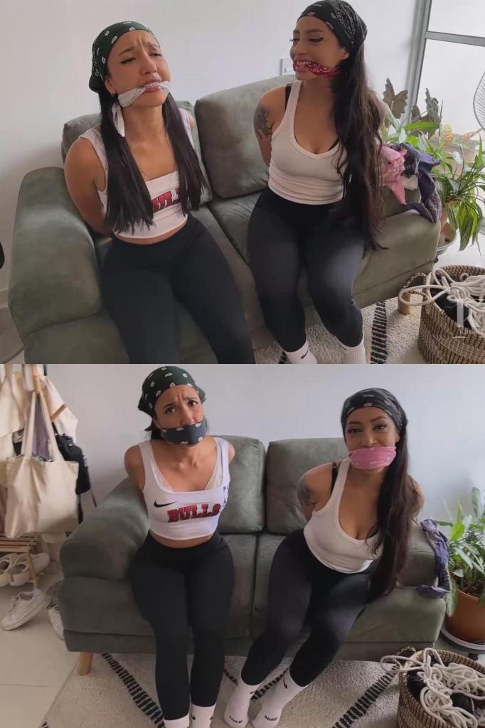 Mara Wheedles Lucia for Some Bandana Gag Fun 玛拉邀请你把她和她犹豫不决的朋友露西亚绑起来。你先绑住露西亚的手腕，玛拉则用布条紧紧堵住她的嘴，让她无法发出抗议。露西亚挣扎着，怒视着玛拉，玛拉很享受这种戏弄。然后玛拉要求也给她一个紧实的口塞，要求塞得她的脸颊都要鼓起来。两个女人现在都被绑着，嘴里塞着东西，互相用口塞交流，挣扎着想要摆脱束缚。经过一番激烈的互动后，她们的口塞被取了下来，露西亚冲你大发雷霆。玛拉怂恿你再塞住露西亚的嘴，露西亚愤怒地拒绝了。你打断了露西亚的怒吼，用手帕塞住她的嘴，并按照OTM（手拉手）的方式系好，让她的眼睛凸了出来。玛拉渴望轮到自己，欣然接受了新的口塞，两个女人隔着口塞互相挣扎，用口塞交流。Mara invites you to tie her and her hesitant friend Lucia up. You begin by binding Lucia's wrists, and Mara cleave gags her tightly, silencing her protests. Lucia struggles and glares at Mara, who enjoys the tease. Mara then requests a tight gag for herself, demanding it to be so tight that her cheeks bulge. Both women, now bound and gagged, engage in gagtalk and struggle against their bonds. After some intense interaction, their gags are removed, and Lucia rages at you. Mara encourages you to gag Lucia again, which she angrily refuses. You interrupt Lucia by stuffing her mouth and tying the bandana OTM style, making her eyes bulge. Mara, eager for her turn, accepts her new gag enthusiastically, and both women struggle and gagtalk at each other through their gags.