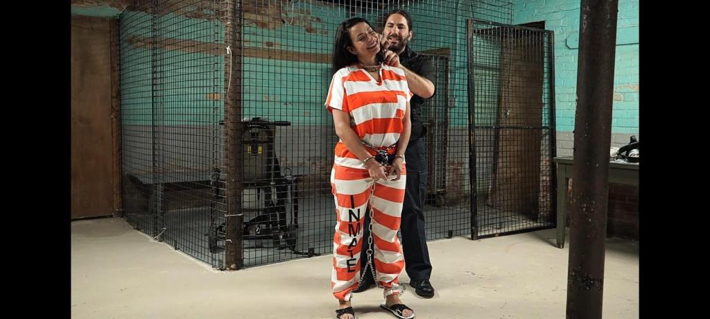 JJ tries out new inmate uniforms JJ is one of the longest-serving inmates in the city jail. She has an exceptional record, despite having been one of the most dangerous criminals in the institution in her past. Time has passed, and her behavior has improved, allowing her to enjoy certain privileges within the prison, such as getting close to the officers. This led to a relationship with one of the guards, with whom she spends some time in secret, since it's forbidden for guards to have relationships with inmates. But what does it matter to JJ and the officer? The risk is worth it. One night, the officer with whom JJ is involved is tasked with testing the new uniforms and security equipment. He's informed that he'll have to choose one of the inmates to perform this task, and who better than JJ? So that same night JJ was more than happy to help her man by trying on the new uniform and handcuffs, stepping out of the prisoner role a little, now a situation that would allow them both to enjoy playing with handcuffs in a private place inside the prison.<br><br>