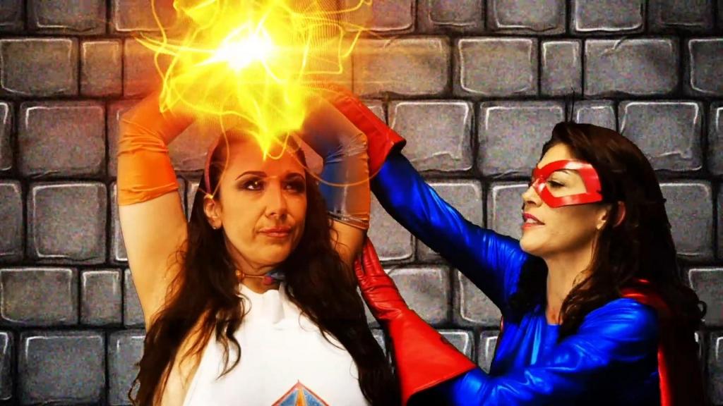 SUPERHEROINE AGENDA-UNCHAINED MALADY Part 2 of 4 Chapter Two: Compass (Kymberly Jane), with the aid of the Capacitor, uses her teleportation powers to send her and Sunburst (Angela Sommers) through an interdimensional vortex where they both get separated from each other. Compass ends up in a dark dungeon where she finds Prism bound to a wall by energy manacles. Sunburst finds herself in a foggy void where she locates a strangely emotionless Daisy Chain (Stacy Burke). When Compass and Sunburst are each attacked by the heroine they sought to rescue, it becomes all too evident that Prism and Daisy Chain are not who they appear to be. Another special effects filled adventure from the mind of director, writer and comics legend George PÃ©rez!<br>第二章：指南针（金伯莉·简饰）借助电容器的力量，利用她的传送能力将自己和旭日（安吉拉·萨默斯饰）送入一个跨维度漩涡，两人因此失散。指南针最终来到一个黑暗的地牢，发现棱镜被能量手铐束缚在墙上。旭日则身处一片迷雾弥漫的虚空，在那里她遇到了一个异常冷漠的雏菊链（斯泰西·伯克饰）。当指南针和旭日分别遭到她们想要营救的女超人的攻击时，棱镜和雏菊链的真实身份才逐渐显露。又一部由导演、编剧兼漫画传奇人物乔治·佩雷斯倾力打造的女英雄特效冒险故事！
