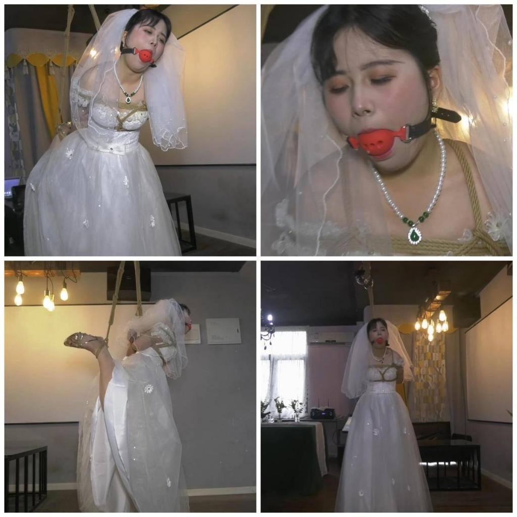 会所里捆绑婚纱女M 穿着婚纱的女M被主人戴上口球，单腿吊缚在会所里折磨，口水不停地流，非常难受。<br>另外招聘模特，喜欢做模特拍片可以联系我们，定拍QQ342642509