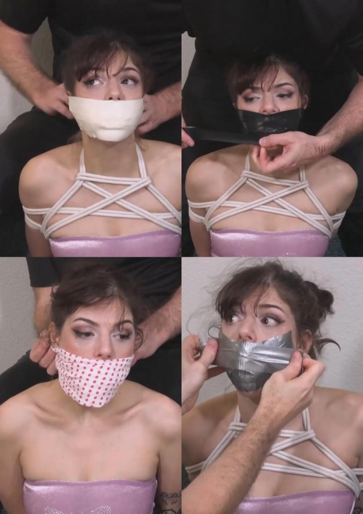 Josie Jo - Babysitter Wants Better Bondage 夜已深，保姆乔西允许她照看的那群小淘气玩他们最喜欢的游戏——把她绑起来堵住嘴。孩子们上床睡觉，留下乔西被绑得结结实实，等着继父回家发现。这已经不是第一次了，继父开始怀疑乔西可能对捆绑游戏感兴趣。他决定把乔西绑得更紧，堵住她的嘴，希望能让她玩得更尽兴！<br><br>堵嘴方法一：<br><br>那群小淘气用两条女式手帕塞住乔西的嘴，然后用一块波点布把她的嘴封住。<br><br>堵嘴方法二：<br><br>继父给乔西戴上胸带后，又往她嘴里塞了两只袜子，并在她的嘴唇上贴了六条银色胶带。<br><br>堵嘴方法三：<br><br>乔西的嘴里塞了两条小内裤，下半张脸被两英寸宽的微孔泡沫胶带缠住。It’s getting late and babysitter Josie allows the rascals she’s watching to play their favorite game, which involves tying and gagging her. They go to bed, leaving her all tied up for their step-dad to find when he gets home. This isn’t the 1st time this has happened, leading him to suspect Josie might be into bondage. He decides to tie and gag her more effectively in hopes of giving her more fun!<br><br>Gag 1:<br><br>The whippersnappers stuff Josie’s mouth with 2 women’s hankies and tie a polka dotted cloth over her mouth.<br><br>Gag 2:<br><br>After adding a chest harness, the step-dad works 2 socks into Josie’s mouth and smooths 6 strips of silver duct tape over her lips.<br><br>Gag 3:<br><br>2 small pairs of panties are packed in Josie’s mouth and 2-inch microfoam tape is wrapped over her lower face