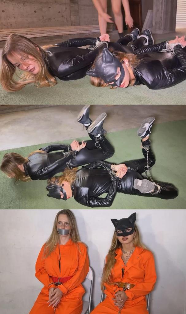 The arrest of catwoman Savannah and the thief Kirby 柯比身穿黑色乳胶紧身衣，猫女萨凡纳也穿着黑色乳胶紧身衣，戴着面具，她们坐在车里。<br><br>她们在犯下另一桩罪行后试图逃跑。<br><br>但萨凡纳被一名女警发现并逮捕。她们被要求双手抱头下车，面向汽车站立。然后，女警命令萨凡纳用脚镣、腰链、连接链和铰链式手铐将柯比铐住，并让她脸朝下趴在地上。<br><br>之后，女警用同样的方法铐住萨凡纳，并让她趴在柯比旁边，以便女警可以安心地搜查车辆。随后，女警押送她们步行前往监狱。<br><br>到达监狱后，她们被拍了入狱照，照片中她们戴着手铐，萨凡纳戴着面具。之后，她们被关进牢房等待。<br><br>过了一会儿，女警终于回来了，手里拿着两件橙色长袖囚服，还有一条皮带和一条红皮带。罪犯们必须穿上囚服。猫女萨凡纳把橙色囚服套在黑色乳胶紧身衣外面，柯比则把红白条纹囚服套在黑色乳胶紧身衣外面。她们都戴着脚镣、连接链和铰链式手铐。柯比还系着一条红皮带，猫女萨凡纳系着一条皮带。<br><br>之后，她们被带到法庭，在那里她们挣扎反抗，难以保持冷静。女警不得不再次用灰色胶带封住柯比的嘴，让她安静下来。<br><br>回到监狱后，她们又要拍警照，拍照时两人都竖起了中指，所以女警只好把她们的背锁起来，重新拍了一张合适的照片。<br><br>然后，她们再次被锁在一起。最后，她们终于被送进了牢房。为了防止逃跑，他们在里面也被锁链拴在墙上。Kirby, wearing black latex catsuit, and Catwoman Savannah, wearing also a black latex catsuit and her mask, are in a car.<br>They try to escape after another bad crime.<br>But Savannaht a policewoman see them and place them under arrest. They need to go outside the car with hands on head and to stand facing the car with hands the car. Then the policewoman asks Catwoman Savannah to chains Kirby with legirons, belly chains, connector chains and hinghed handcuffs in back, then she need to lying face on the ground.<br>After that, the policewoman chains Catwoman Savannah in the same way and Catwoman Savannah need to lying next to Kirby so the policewoman can chains them together. So she can search the car with peace. After that, the policewoman holds them to jail on foot.<br>Once arrived in jail, there's entry mugshot for them, with handcuffs in front, Catwoman Savannah keeps her mask. Then, they need to wait in a cell.<br>After a while, the policewoman finally comebacks with two orange long sleeved prison jumspuits and with also one leather belt and one red belt. The criminals have to wear the jumpsuit. Catwoman Savannah wears the orange one on top on her black latex catsuit and Kirby wears the red and white stripped on top of her black latex catsuit. They're both legirons, connector chains and hinghed handcuffs in front. Kirby has also a red belt and Catwoman Savannah a leather belt.<br>After that, they go to the court where they struggle and don't stay calm. The policewoman has to put again an grey tapes gag just on the mouth of Kirby to get some peace and quiet.<br>Back to jail, there's another police pictures for them, they both give middle fingers during the police pictures, so the policewoman has to chains them in back and to retake police pictures to have correct one.<br>Then, they're one again chained together. Then, they finally enters in their cell. Inside they're also chained to the wall to avoid an escape.
