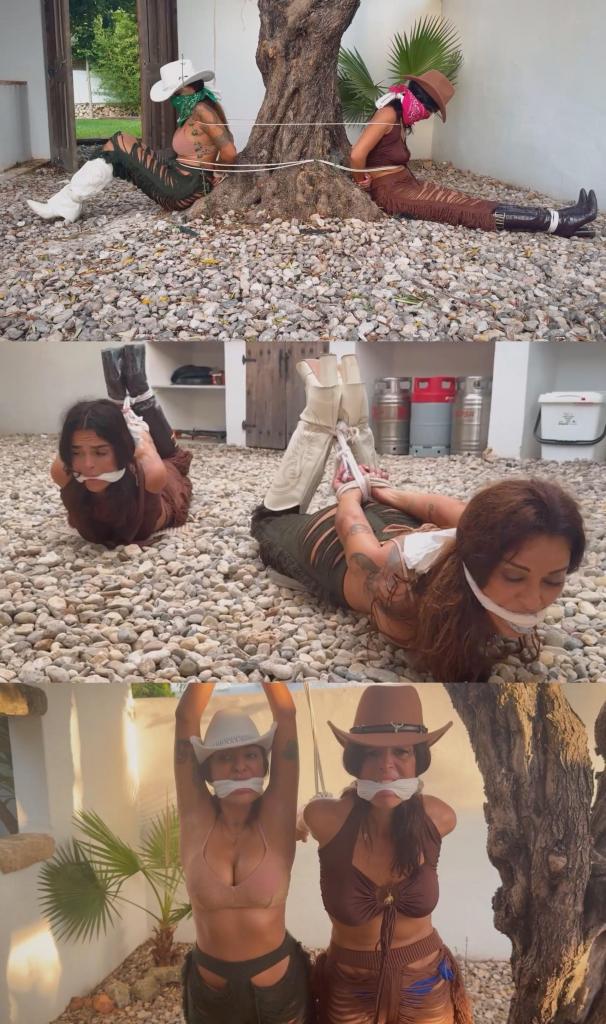 Bandit Girls Tied Tight. Two Helpless Cowgirls Cleave Gagged to a Tree and Rough Ropes Hogtie 拉蒂娜和洛拉·卢穿过灌木丛。她们是一对引人注目的亡命之徒，穿着粗犷却不失优雅的牛仔女匪徒装束。两人都穿着饱经风霜的皮靴，头上戴着随时可以蒙住脸的深红色头巾。<br><br>几个星期以来，她们一直听到传言，说在山谷深处一处偏僻的防御工事里藏着一批赃物——铁路劫案中偷来的金银珠宝。寻宝的刺激驱使着她们，当她们翻过最后一个山脊时，那处房产映入眼帘：一个被高高的石墙环绕的广阔牧场，四周寂静无声，仿佛带着某种捕食者的气息。<br><br>趁着傍晚的阴影，她们擅自闯入。她们动作协调，优雅地从围墙的缝隙中钻过，蹑手蹑脚地走向一扇隐藏在枯枝落叶下的厚重铁门。她们屏住呼吸，满怀期待地撬开了铁门。在昏暗的地窖灯光下，赃物闪闪发光：沉甸甸的金币袋和精美的银饰，仿佛散发着某种内在的光芒。<br><br>“我们发财了，拉蒂娜！”洛拉·卢低声说道，眼中满是贪婪。<br><br>她们抓起赃物，沉重的金子拉扯着她们的手臂，然后飞快地向地界跑去。她们拼命奔跑，肾上腺素飙升，靴子敲击着干燥的泥土。但当她们跑到地界边缘时，一声洪亮的声音打破了寂静。<br><br>“女士们，要去哪儿？”<br><br>她们还没来得及反应，就被拦住了。赃物的主人——一个身材魁梧、满脸胡茬、目光如炬的男人——和他的雇工们扑了过来。搏斗短暂而激烈，双方都处于下风。金子被残忍地从他们手中夺走，强盗们被按倒在地，脸埋在泥土里。<br><br>主人不相信监狱，他相信教训。他把他们拖到空地边缘一棵巨大的古老橄榄树旁。他用一根粗糙的粗麻绳，开始把他们绑成吊刑的姿势。他把他们的手臂拉到背后，用力地勒紧他们的手腕，让他们痛苦不堪。然后，他把绳子绕过一根粗壮的树枝，把他们吊了起来。<br><br>拉蒂娜和洛拉·卢被吊离了双脚，肩膀在自身重量的压迫下绷得紧紧的。吊刑的姿势让她们完全暴露，毫无反抗之力，胸部向前挺出，双臂被紧紧地拉在身后。为了确保她们无法呼救或求饶，主人拿出几条粗糙的亚麻布条。他将布料深深塞进他们的嘴里，填满他们的口腔，直到他们几乎无法用鼻子呼吸。为了固定住填充物，他用皮带勒住他们的嘴——皮带紧紧地缠绕在他们的头上，在脖子后面扣上，将布料牢牢地固定住。<br><br>他们就这样被吊了一个小时，在微风中轻轻摇晃，被压抑的呜咽声淹没在橡树叶的沙沙声中。肩膀上的疼痛如同沉闷的、阵阵的轰鸣，口塞让他们每一次呼吸都异常艰难。他们不再是强盗；他们只是一个冷酷无情之人正义的装饰品。<br><br>当太阳开始西沉，在地面上投下长长的紫色影子时，主人觉得教训已经结束了。他把他们从树上放了下来，但他还没玩够。他把他们拖过泥地，来到马厩附近一片平坦冰冷的石板地上。<br><br>他冷酷而有条不紊地将她们从吊刑架上换成了紧紧的猪蹄式捆绑。他将她们被绑住的手腕拉向脚踝，粗暴地拽紧绳索，直到她们的身体被紧紧地弓起。她们的脊椎弯曲，脚后跟抵着腰部，使她们完全暴露在众人的视线之下。<br><br>主人后退一步，俯视着两个被绑住的女牛仔。她们鲜红的头巾沾满了灰尘，靴子也磨损了，她们压抑的呻吟声在石板地上回荡。他把她们留在那里——猪蹄式捆绑，嘴里塞着东西，在冰冷的石板地上瑟瑟发抖——任由沙漠的夜色笼罩着她们，让她们反思自己贪婪的代价。Latina and Lola Lu walk through the scrubland. They were a striking pair of outlaws, dressed in the rugged elegance of cowgirl bandits. Both wore weathered leather boots and crimson bandanas ready to be pulled up over their faces at a moment's notice.<br><br>For weeks, rumors had reached them of a hidden cache of loot—stolen gold and jewelry from a railway heist—stashed on a secluded, fortified estate deep in the valley. The thrill of the hunt had driven them, and as they crested the final ridge, the property came into view: a sprawling ranch surrounded by a high stone wall and guarded by a silence that felt predatory.<br><br>Under the cover of the late afternoon shadows, they trespassed. They moved with a synchronized grace, slipping through a gap in the perimeter and creeping toward a heavy iron cellar door hidden beneath a layer of dried brush. With a collective breath of anticipation, they pried the door open. There, gleaming in the dim light of the cellar, was the loot: heavy bags of gold coins and ornate silver trinkets that seemed to glow with an inner light.<br><br>"We're rich, Latina!" Lola Lu whispered, her eyes wide with greed.<br><br>They grabbed the loot, the weight of the gold pulling at their arms, and bolted back toward the perimeter. They ran with a desperate, adrenaline-fueled speed, their boots pounding the dry earth. But as they reached the edge of the property, a booming voice shattered the silence.<br><br>"Going somewhere, ladies?"<br><br>Before they could react, they were intercepted. The owner of the loot—a massive, grizzled man with a gaze as hard as flint—and his hired hands descended upon them. The struggle was brief and one-sided. The gold was ripped from their grasp with a brutal efficiency, and the bandits were pinned to the ground, their faces pressed into the dirt.<br><br>The owner didn't believe in jails; he believed in lessons. He dragged them toward a massive, ancient olive tree at the edge of the clearing. With a coarse, heavy-duty hemp rope, he began to bind them in a strappado position. He pulled their arms behind their backs, cinching their wrists together with agonizing tightness. Then, he looped a rope over a sturdy branch and hoisted them up.<br><br>Latina and Lola Lu were lifted off their feet, their shoulders straining under the unnatural tension of their own body weight. The strappado position left them completely exposed and utterly helpless, their chests thrust forward and their arms pulled taut behind them. To ensure they couldn't scream for help or beg for mercy, the owner produced strips of rough linen cloth. He stuffed the fabric deep into their mouths, filling their oral cavities until they could barely breathe through their noses. To secure the stuffing, he applied cleave gags—leather straps that wrapped tightly around their heads, buckling behind their necks and pushing the cloth to stay firmly in place.<br><br>For an hour, they hung there, swaying slightly in the breeze, their muffled whimpers lost in the rustle of the oak leaves. The pain in their shoulders was a dull, throbbing roar, and the gags made every breath a struggle. They were no longer bandits; they were mere ornaments of a ruthless man's justice.<br><br>As the sun began to dip below the horizon, casting long, purple shadows across the land, the owner decided the lesson was complete. He lowered them from the tree, but he wasn't finished with them yet. He dragged them across the dirt to a flat, cold expanse of hard stone flooring near the stables.<br><br>With a cold, methodical precision, he transitioned them from the strappado into tight hogties. He pulled their bound wrists back toward their bound ankles, cinching the ropes with a brutal jerk until their bodies were arched in a tight. Their spines were curved, their heels pressed against their lower backs, leaving them in a position of total vulnerability.<br><br>The owner stepped back, looking down at the two bound cowgirls. Their crimson bandanas were now stained with dust, their boots scuffed, and their muffled moans echoing softly against the stone. He left them there—hogtied, gagged, and shivering on the freezing stone floor—as the desert night closed in around them, leaving them to contemplate the high cost of their greed.