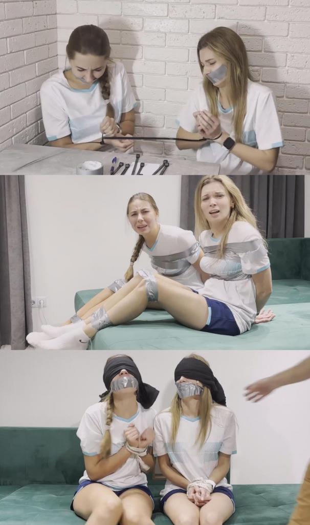 Soccer girls Nastya and Milana bound and gagged by bad guy 首先，他们用扎带绑住女孩们的手腕，用胶带封住她们的嘴。女孩们愤怒地呻吟着。<br><br>在第二个场景中，女孩们靠墙坐着。她们的双手被反绑在背后，嘴巴被胶带封住，眼睛也被蒙住。坏人摘下她们的眼罩，把她们扶了起来。<br><br>下一个场景中，女孩们坐在沙发上，被胶带捆绑着。她们呻吟着呼喊坏人的名字，希望他能帮助她们。<br><br>但坏人并没有帮助她们。在接下来的场景中，女孩们再次被胶带封住嘴巴，眼睛也被蒙住。坏人把她们带到另一个房间，那里正在进行她们球队的足球比赛。女孩们眼睁睁地看着自己的球队输球，愤怒地呻吟着。First they tie their wrists with zip ties and gag their mouths with duct tape. Girls are angry and moaning a lot.<br><br><br>In the second scene, the girls are sitting against a wall. Their hands are tied behind their backs, their mouths are tape gagged, and their eyes are blindfolded. The bad guy removes their blindfolds and stands them up.<br><br><br>The next scene shows the girls sitting on a couch and tape bounded. They moanning and calling for the bad guy. They hope he can help them.<br><br><br>But the villain did not help them. In the next scene, the girls are again tape gagged and blindfolded. The bad guy takes them to another room where their team's football match is going on. The girls watch their team lose and get angry and moan a lot.