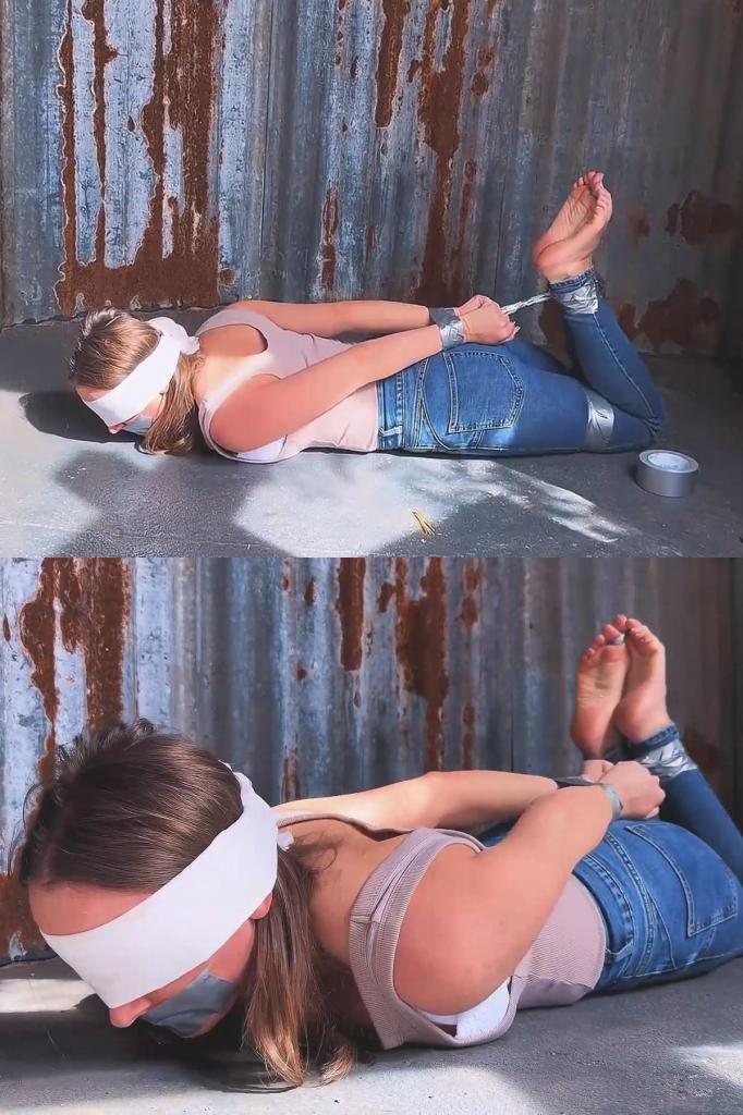 Duct Tape Bondage Hogtie - Outside 看着我挣扎着屈服，被胶带捆绑成猪蹄状。紧身牛仔裤、背心和胶带封住的嘴巴，露出被胶带缠住的脚趾和性感的赤脚。Watch me struggle into submission, in a duct tape bondage hogtie. Taped toes and sexy barefoot soles on display in tight jeans, tank top and tape gag.