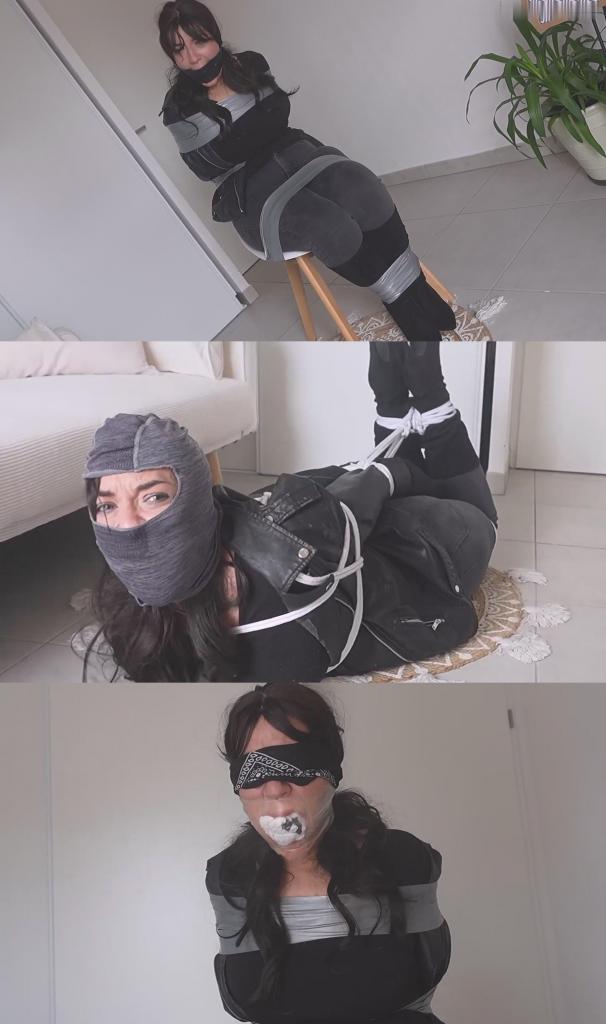 The French Girl -The Burglar Was Tied Up And Gagged By The Strange Owner 一名女窃贼闯入一名男子的公寓，他似乎藏匿着贵重物品。不幸的是，她犯了一个严重的错误。<br><br>当她在公寓里搜寻这些物品时，男子返回并从背后抓住了她。他特意戴上了巴拉克拉法帽，以免被人认出。但他为什么要这么做呢？他是房主，完全可以报警。显然，这名男子另有打算。<br><br>他把她带到另一个房间，用胶带把她牢牢地绑在椅子上，然后——为了让她闭嘴——用一个巨大的口塞堵住了她的嘴！这名男子装备精良，这肯定不是他第一次这么做了。他趁机抚摸了窃贼的胸部；她隔着口塞发出愤怒的呻吟：“啊 ...计划很简单：下次她再行窃，就要分给他一半赃物。男人考虑了一会儿，最终还是拒绝了。他回到卧室，从洗衣篮里拿出一只又大又脏的白袜子，回来后塞进窃贼张开的大嘴里；她尝到袜子的味道，厌恶地呻吟起来。显然，男人对她另有打算。然后，他用透明胶带封住了她的嘴。这是一个威力十足且有效的封口装置，同时也是对她试图抢劫他的惩罚。最后，他蒙住了窃贼的眼睛。然后，他把她扔在那里，让她在被捆绑、堵嘴、蒙眼的状态下挣扎了几个小时，完全无助。几个小时后，男人回来了，再次取下窃贼嘴里那可怕的封口物，开始解开她的绳子，告诉她他对她另有安排。<br><br>她发现自己被绳子捆绑着，躺在地板上，他把她捆成猪蹄状。然后，他把那条头巾——他先用它遮住自己的脸，然后蒙住她的眼睛，现在又用来堵住她的嘴——塞进了窃贼的嘴里。最后，他又用银色胶带缠住她的嘴，一圈又一圈地缠绕。这么多绳子缠着，她根本挣脱不了，嘴里塞得这么紧，她也根本说不出话来！男人告诉她，她有两个选择：要么忍受这样的命运，要么就去报警。但接下来会发生什么呢？<br><br>接下来的事情很简单：她不停地挣扎，男人又给她套上一个巴拉克拉法帽，把堵嘴的东西遮住了。现在，除了窃贼眼中那可怜的绝望，什么也看不见；她拼命地挣扎呻吟，却不知道他为什么要这样做，也不知道等待着她的是什么。A female burglar breaks into the apartment of a man who appears to be hiding valuables. Unfortunately for her, she has made a grave mistake.<br><br>While she is searching the apartment for these items, the man returns and catches her from behind. He has taken care to put on a balaclava so he won't be recognized. But why? He is the owner; he could simply call the police. This man clearly has other plans.<br><br>He takes her into another room and ties her securely to a chair with tape, then—to silence her—stuffs a huge panel gag into her mouth! This man is well-equipped; this is surely not the first time he has done this. He takes the opportunity to touch the burglar's breasts; she moans in rage through the gag: "Aaargggmm-MMMMHHPPHHFFAARGNN!!!"<br><br>After several long minutes, the man returns and removes the gag from the burglar's mouth. She immediately seizes the chance to propose an idea to convince him to let her go. The idea is simple: for her next burglary, she will give him half the loot. The man considers it for a moment but ultimately refuses. He heads to his bedroom, retrieves a large, dirty white sock from the laundry basket, returns, and stuffs it into the burglar's wide-open mouth; she moans in disgust as she tastes the sock. Clearly, the man has other plans for her. He then seals her mouth with clear tape. It is a formidable and effective gag, serving also as punishment for her attempt to rob him. Finally, he blindfolds the burglar. He then leaves her to struggle for hours—bound, gagged, and blindfolded—completely helpless. After several hours, the man returns, removes the hideous gag from the burglar's mouth once more, and begins to untie her, telling her he has other plans for her.<br><br>She finds herself bound with ropes, lying on the floor, as he ties her up in a hogtied position. Then, he stuffs the bandana—which he had first used to conceal his face, then to blindfold her, and now to silence her—into the burglar's mouth. Finally, he wraps silver duct tape around her mouth again, winding it round and round. It is impossible to break free with all those ropes, and impossible to speak or make herself heard with such a massive gag! The man explains that she has a choice: suffer this fate or deal with the police. But what will happen next?<br><br>What follows is simple: she struggles ceaselessly, and the man pulls another balaclava over her head, thereby concealing the gag. Now, nothing is visible but the pathetic despair in the burglar's eyes; she struggles and moans as best she can, unaware of why he is acting this way or what awaits her.