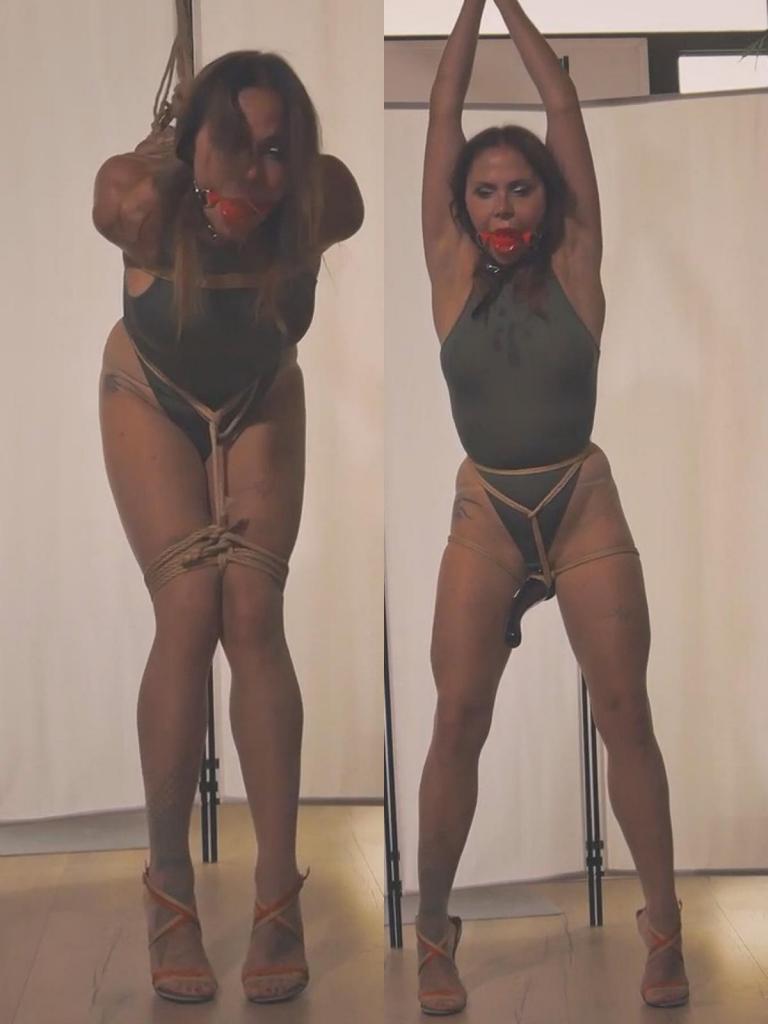 Luna - The kinky lottery - Strappado, bound orgasm with vibrator, rope bondage, ball gagged, spankin Luna - The kinky lottery - Strappado, bound orgasm with vibrator, rope bondage, ball gagged, spanking, high heels sandals, struggling, vibrator endurance 场景开始时，露娜慵懒地躺在沙发上，身着紧身绿色连体衣、无缝肉色丝袜和洁白的运动袜。伊万站在她面前，手里拿着五张折叠的纸条。“选一张，”他轻声说道，“上面写着什么，你就照做。”露娜的手指在纸条间徘徊，最终停在一张纸条上。她展开纸条。*绞刑*<br><br>绳索出现之前，伊万命令露娜脱掉白袜子，露出穿着尼龙袜的双脚，然后穿上一双六英寸高的凉鞋。高跟鞋瞬间让她踮起脚尖，小腿肌肉紧绷，身体摇摇欲坠。这是她第一次接受绞刑。后果不堪设想。<br><br>他扶她站起来。她的手腕被紧紧地绑在背后，然后又被绑在手肘上。第三根绳子系在她的手腕上，向上拉扯。她双臂向后伸展，肩膀耸起，躯干向前弯曲，紧张感不断加剧。她脚踩着细如刀尖的高跟鞋，身体摇晃，每一块肌肉都在颤抖，努力保持平衡。接着，球形口塞滑入她的口中，封住了她的声音，只留下闷闷的呼吸声和绳索轻微的摩擦声。<br><br>她的双腿在膝盖以上被绑住，让她无法迈步或保持平衡。她只能原地缓慢旋转，身体前倾，双臂高高地向后伸展，完全依靠脚尖支撑，脚下踩着那双令人痛苦的凉鞋。她忍受着。<br><br>然后，伊万改变了游戏规则。他小心翼翼地解开她的绳索，让她喘息片刻，然后重新将她的手腕绑在身前。他把她带到悬吊点，将她的双臂举过头顶，直到她完全伸展开来，再次用脚尖支撑着她那双六英寸高的凉鞋。她的身体紧绷、伸展，脆弱不堪。<br><br>他拿起一个振动器，用绳子精准地固定在她两腿之间，让她无处可逃。他打开开关。振动瞬间涌遍全身。她动弹不得，只能扭动臀部，追逐这股感觉，在抵抗与臣服之间摇摆不定。口塞让她呼吸急促，脚趾在凉鞋里蜷缩起来。她的身体仿佛成了纯粹而无法控制的感官体验的容器。<br><br>她悬在那里，身体伸展，颤抖不已，徘徊在极限边缘，被困在快感与疲惫、控制与释放之间。The scene opens with Luna lounging on the couch, dressed in a form-fitting green bodysuit, seamless nude pantyhose, and crisp white athletic socks. Ivan stands before her holding five folded slips of paper. “Pick one,” he says softly. “Whatever it says, you do.” Luna’s fingers hover, then settle on a single ticket. She unfolds it. *Strappado.*<br><br>Before the ropes come out, Ivan tells Luna to peel off her white socks, revealing her nylon-clad feet, and to slide them into towering 6-inch sandals. The heels push her onto her tiptoes instantly, her calves tensing, her balance already precarious. This is her first strappado. The stakes are real.<br><br>He guides her to standing. Her wrists are bound tightly behind her back, then lashed at the elbows. A third rope attaches to her wrists and pulls upward. Her arms rise behind her, her shoulders stretch, her torso bends forward as the tension mounts. She sways on the razor-thin heels, every muscle trembling to maintain equilibrium. The ball gag slides between her teeth next, sealing her voice, leaving only muffled breaths and the soft creak of rope.<br><br>Her legs are bound above the knees, eliminating any chance of stepping or stabilizing. She can only rotate slowly in place, bent forward, arms pulled high behind her, balanced entirely on the balls of her feet in those punishing sandals. She endures.<br><br>Then Ivan changes the game. He unties her carefully, lets her breathe for a moment, then rebinds her wrists in front. He leads her to the suspension point and hoists her arms overhead until she is fully extended, once again pushing onto her tiptoes in the 6-inch sandals. Her body is taut, stretched, vulnerable.<br><br>He takes a vibrator and secures it between her thighs with precise rope work, positioning it exactly where she cannot escape it. He turns it on. The vibrations surge through her. She cannot shift away. She can only move her hips, chase the sensation, resist and surrender in equal measure. Her breath quickens behind the gag. Her toes curl inside the sandals. Her body becomes a vessel of pure, uncontrollable feeling.<br><br>She hangs there, stretched, vibrating, balanced on the edge of endurance, trapped between pleasure and exhaustion, control and release.