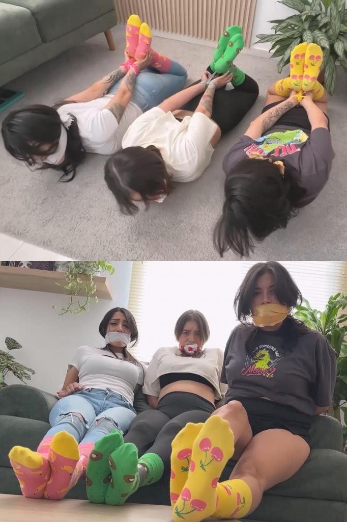 Colored Socks Lover Broke in: Simona, Mara &amp; Luana Sock Stuffed 西蒙娜穿着牛仔靴、裙子和樱桃黄袜子。她脖子上围着一条金色丝巾。她全身用黄色胶带缠住，丝巾被用作口塞。橙色西瓜黄袜子被用作填充物。Simona is wearing cowboy boots, a skirt, and yellow cherry socks. She has a golden silk scarf around her neck. She is taped up using yellow tape, with the bandana as an OTM gag. Orange watermelon socks are used as stuffing.