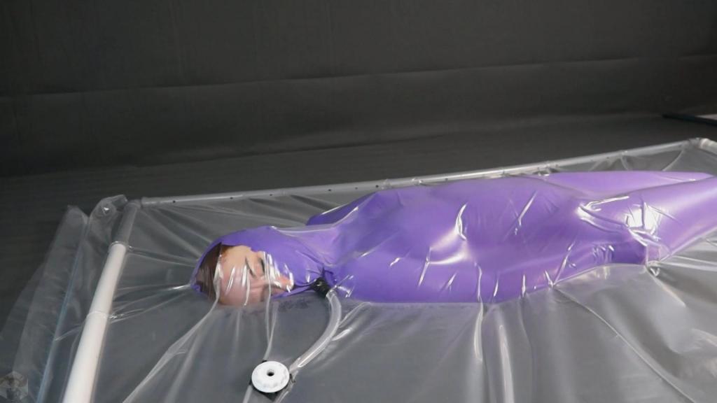 Purple nylon in a polyethylene vacuum bed Today Sonya put on a purple nylon cocoon. But that's not all. The girl in it climbed into a polyethylene vacuum bed. Sonya moved and enjoyed such an experiment.