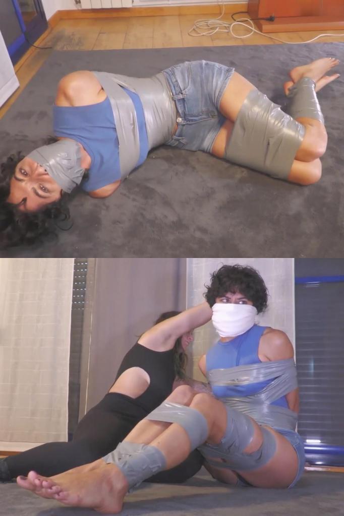 Roommate gets tied up and gagged 俊和玛格特是室友。俊需要点钱，于是翻找玛格特的东西，看看能不能找到什么。但玛格特看到了她，她可不会让她得逞。她抓住俊的胳膊，用胶带把她的双手绑了起来。“什么……”玛格特用手捂住俊的嘴。她先用一个开口塞堵住她的嘴，然后又用一个口塞和一个小口塞堵住。接着，她用很多胶带把俊绑了起来。但玛格特觉得再加一个口塞会更好看，于是她脱下自己的袜子，用袜子和一大块胶带把俊的嘴堵住。然后她又把俊绑得更紧！俊根本逃不掉。玛格特嘲笑了俊一番后就离开了，留下俊独自一人在那里挣扎。她孤身一人，完全无助，而且看起来无路可逃！Jun and Margout are roommates. Jun needs some cash and she’s looking around Margout stuff to see if she can find anything. But Margout sees her, and she’s not gonna let that happen. She grabs her arms and ties her hands with tape. “What the… Margout handgags her. She gags her with a cleave gag, followed by a OTM and a OTN. Then she ties her up with a lot of tape. But Margout decides she would look better with another gag, so Margout removes her own socks, and gags with Jun with her socks and a huge tapegag. Then she tapes her up even more! No way Jun can escape. After making fun of her, Margout leaves, and Jun is left there struggling. She’s alone, totally helpless, and doesn’t seems she’s going anywhere!
