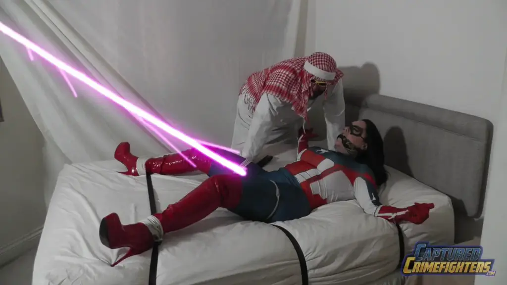 Rara Curves, Spyderchick vs The Sultan, Final Part SpyderChick awakens to find herself tied down to a bed with each of her four limbs stretched out, leaving the helpless heroine in a spreadeagled predicament.<br><br>Thankfully still in her costume and mask, it is of little relief however as the captured crimefighter is cleave-gagged with a tightly knotted silk scarf and looks up towards an ominous-looking device pointing directly at her bound body.<br><br>Cue that evil fiend The Sultan who walks in to taunt SpyderChick and finally reveal his diabolical masterplan to her! The vile villain informs his beautiful captive that the device in question is his latest devious invention, the patented Sultan Sex Ray!<br><br>The shocked superheroine struggles wildly when the evil arab explains that when activated, the sex ray will emit a powerful laser beam directly onto her pussy and will tingle every single one of her nerve endings, bringing the defeated do-gooder endless orgasms!<br><br>Spyderchick cannot believe her ears but when The Sultan switches on the device, a bolt of red light immidiately zaps her crotch and sure enough, the bound brunette instantly starts to feel it's devastating effects as wave after wave of erotic stimulation begins to flow through her.<br><br>But this, according to the Sultan, is only Level 1 on his dastardly machine, so things are about to get a whole lot hotter for the sexed-up superheroine!<br><br>Raising the stakes, the cruel criminal points his remote control gizmo at the laser and cranks it up to Level 2. The red beam immediately becomes green as SpyderChick can feel increasing waves of pulsating energy surging through her crotch.<br><br>Leaving her alone to face the music, SpyderChick struggles in vain as she cannot fo as thing to prevent this endless pounding of her pussy. The shuddering green laser beam sends wave after wave of orgasmic energy flowing through her body, making her shake and tremble in wanton sexual bliss.<br><br>If truth be told, the helpless heroine is in fact, a tremendous slut and cannot help but get aroused when placed in tight bondage and subjected to endless multiple orgasms.<br><br>So right now, the highly-turned on beauty is in a world of extreme ecstasy as the laser beam helps her fire off orgasm after orgasm, reducing the costumed whore to a shuddering sweaty mess.<br><br>Completely unable to move and firing off climax after climax, the stricken superheroine rolls her eyes back into her head and moans lustfully, not even noticing when the Sultan returns. The evil villain gleefully informs SpyderChick that he intends on cranking his machine up to the maximum level...<br><br>But what that will do to her is anyone's guess...?!?