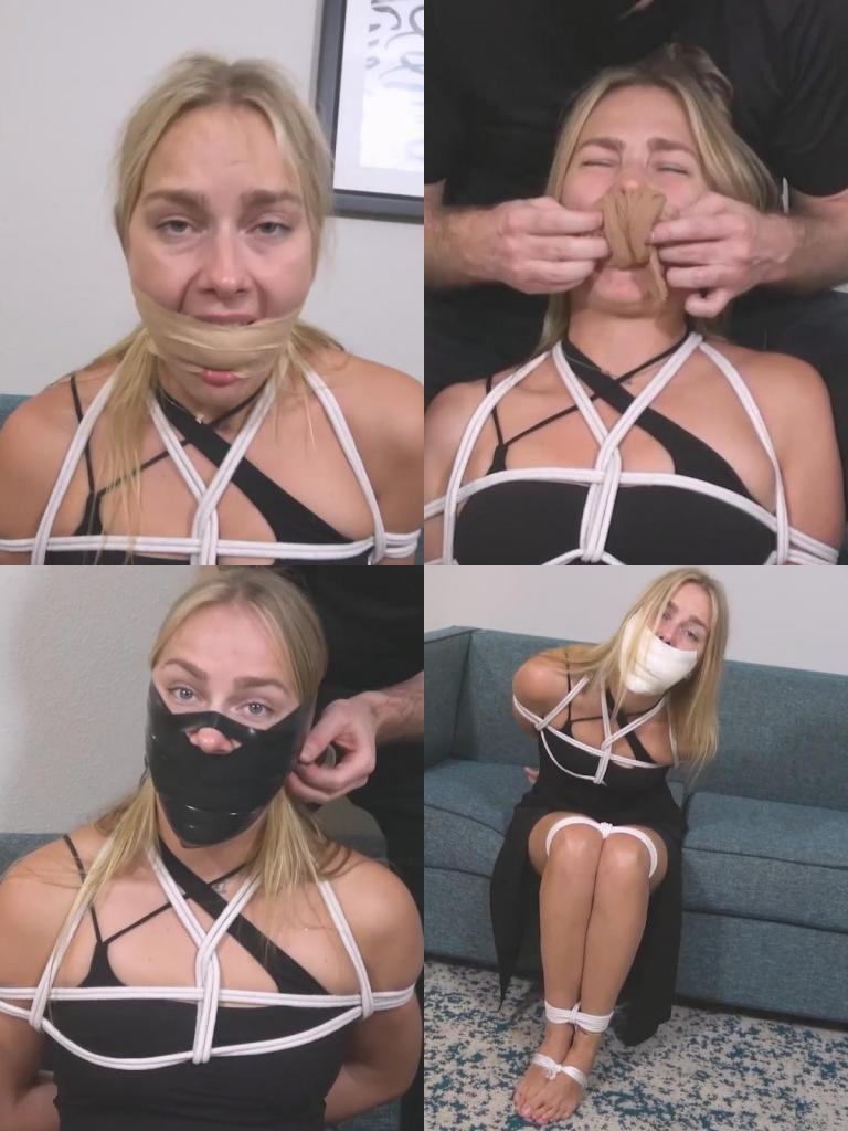 Vika-Mad Gagger Victim Vika 成了连环封口狂魔“Mad Gagger”的最新受害者。由于事先观察过，他知道 Vika 的嘴巴特别大。在将她的手腕、胸部、膝盖、脚踝和双脚一一捆绑固定后，他便着手利用这宽敞的空间大做文章！<br><br>封口方案 1：<br><br>Vika 的嘴里被塞进了一双连裤袜。她本以为这就够了，但 Mad Gagger 随后又往她嘴里塞进了一个 2 英寸（约 5 厘米）大的白色橡胶球。最后，他用 2 英寸宽的棕褐色兽用自粘绷带在她的双唇间缠绕，将这一切牢牢固定住。<br><br>封口方案 2：<br><br>Vika 宽敞的口腔不仅能容纳一块，甚至能塞下两块厚实的工业抹布。这一壮举让 Mad Gagger 印象深刻！他贴上三条 4 英寸（约 10 厘米）宽的微孔泡沫胶带，覆盖住她的双唇，将满口的填充物封在里面。<br><br>封口方案 3：<br><br>最后，他展开一大卷棉质绷带，一点一点地将其全部塞进 Vika 的嘴里。Mad Gagger 决定在她的双唇上层层缠绕电工胶带，以此比较哪种造型更合心意。首先，胶带缠绕范围从鼻翼下方开始，留出了一部分下巴；接着，他增加了缠绕量，将胶带位置上移至脸颊，并覆盖住了下巴；最后，他在鼻梁处也加了一圈胶带。你更喜欢哪种造型呢？Vika becomes the latest victim of the serial gagging maniac, the Mad Gagger. Having scouted her out beforehand, he knows she has a particularly large mouth. Once he has her bound at the wrists, chest, knees, ankles, and feet, he sets about trying to make the most of the ample space!<br><br>Gag 1:<br><br>Vika’s mouth is packed with a pair of pantyhose. She feels like that’s enough but the Mad Gagger pushes a 2-inch white rubber ball in her mouth as well. It’s all held in with tan 2-inch vet wrap wound between her lips.<br><br>Gag 2:<br><br>The spacious mouth of Vika is able to accommodate not 1 but 2 thick shop rags. A feat that impresses the Mad Gagger quite a bit! He smooths 3 strips of 4-inch microfoam tape over her lips to seal in the mouthful.<br><br>Gag 3:<br><br>Finally, a large cotton bandage roll is unfurled and the whole thing is worked into Vika’s mouth bit by bit. The Mad Gagger decided to progressively wrap electrical tape over her lips to see which look he likes better. 1st, the wrap extends from just below her nose and leaves a bit of her chin exposed. Next, he adds more, angling the tape higher on her cheeks and covers her chin. Finally, he adds a turn over the bridge of her nose. Which look do you prefer?